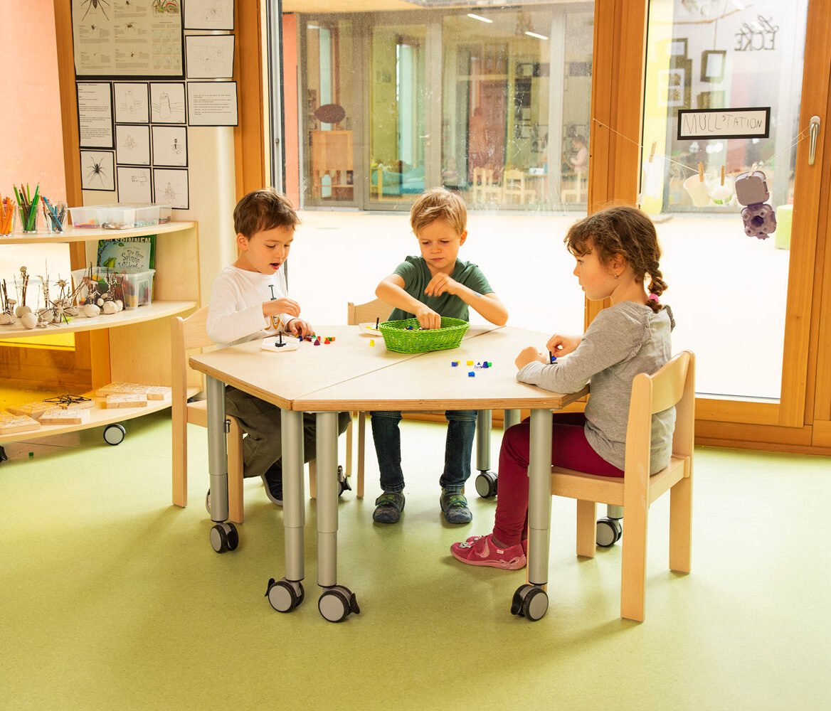 Durable solid wood table for educational settings, adjustable height for various age groups.
