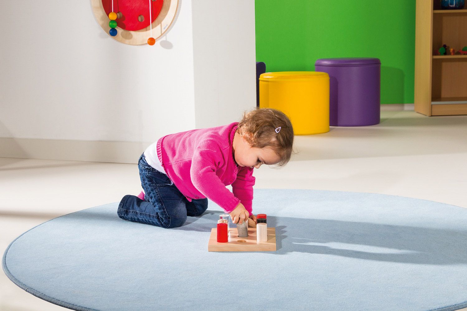 Children interacting with sensory play materials for cognitive development.