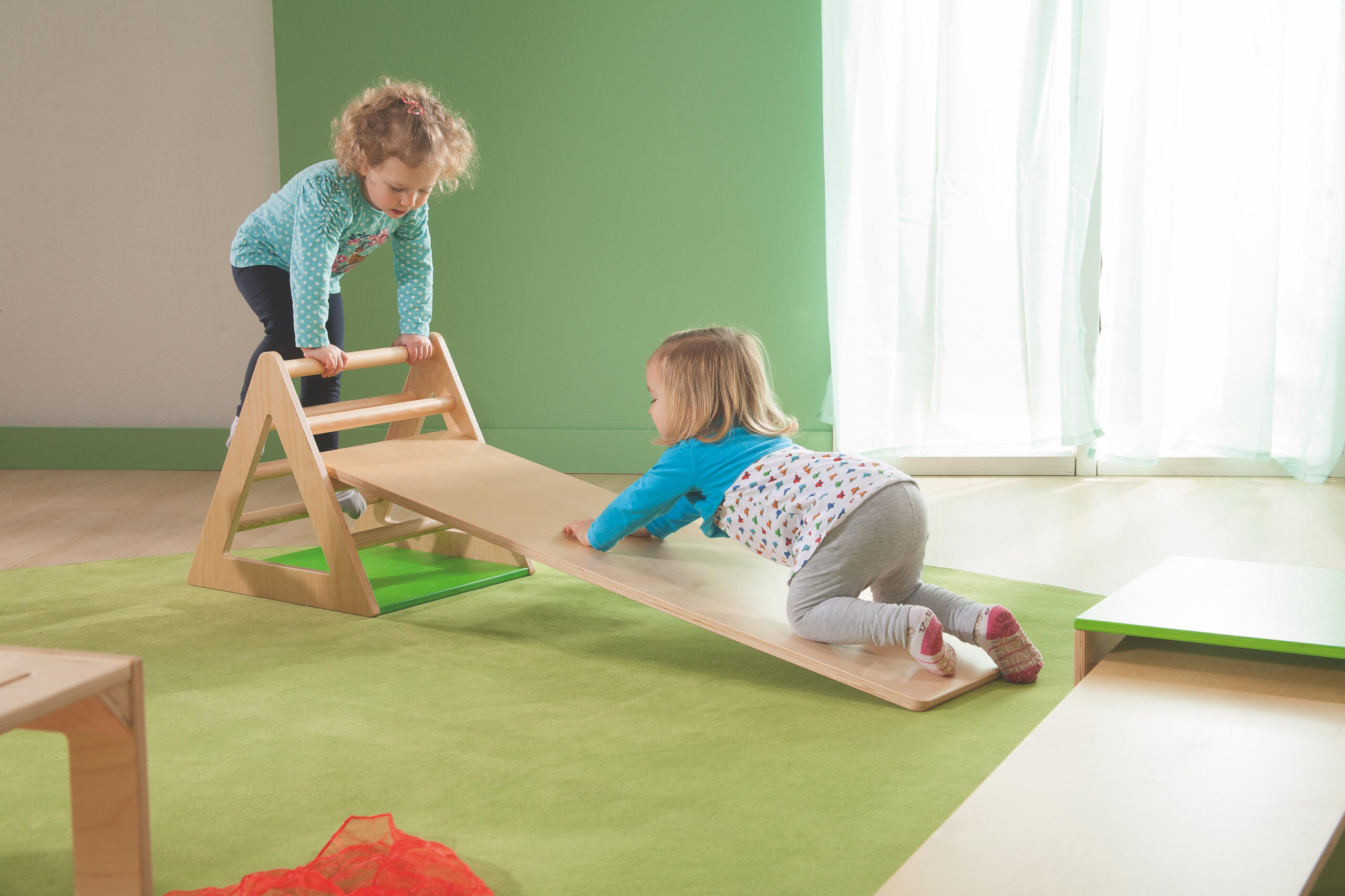 Children using active play equipment to develop motor skills and physical health.