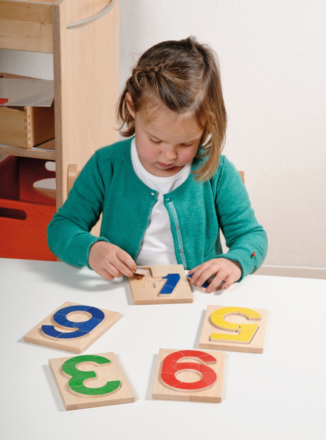 Children exploring shapes and numbers to develop numeracy skills at an early age.